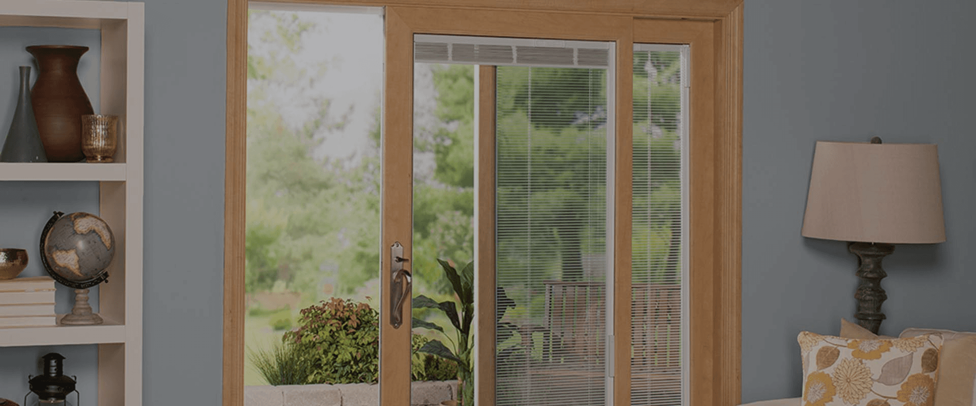A sliding glass door with light-colored wood trim.